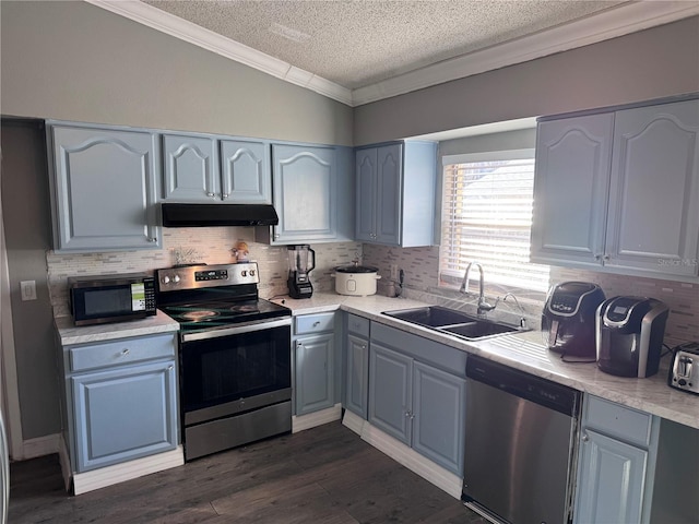 kitchen with appliances with stainless steel finishes, dark hardwood / wood-style floors, tasteful backsplash, sink, and ornamental molding