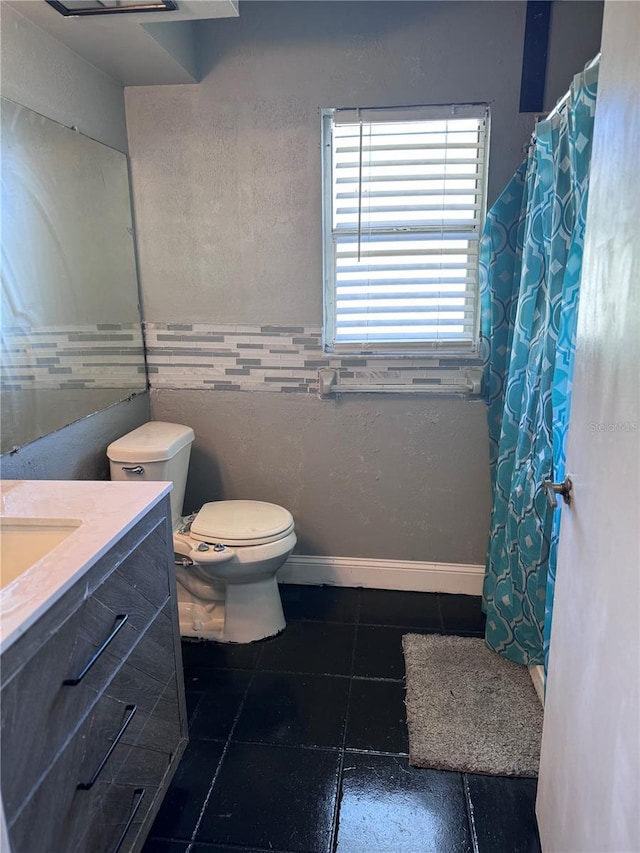 bathroom with vanity, tile patterned floors, and toilet