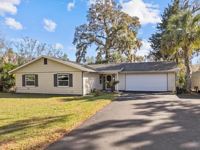 ranch-style house with an attached garage, driveway, and a front lawn