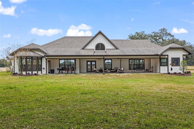 back of property with a yard and a patio area