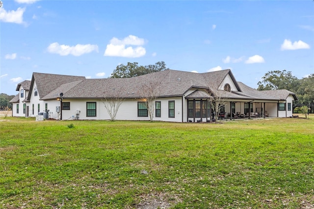 rear view of house with a yard, central AC, and a patio