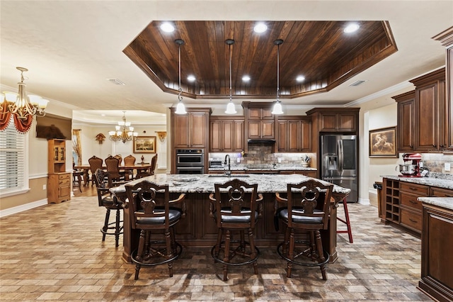 kitchen with wood ceiling, appliances with stainless steel finishes, hanging light fixtures, a spacious island, and a raised ceiling