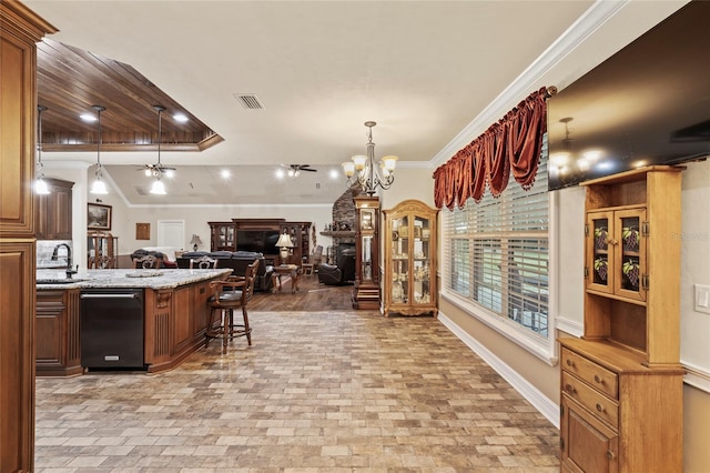 kitchen featuring ceiling fan with notable chandelier, dishwasher, a kitchen bar, ornamental molding, and light stone counters