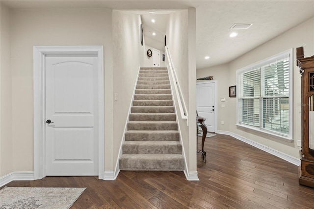 stairs with hardwood / wood-style floors