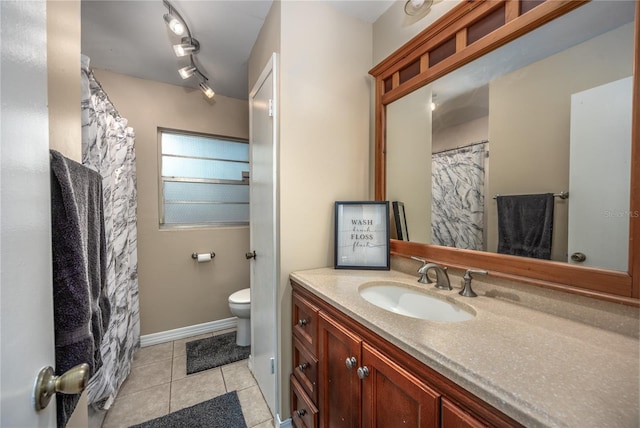 bathroom with vanity, toilet, and tile patterned flooring