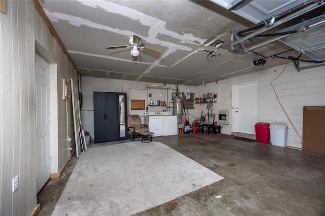 garage with ceiling fan, independent washer and dryer, a garage door opener, and heating unit