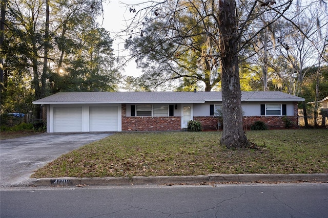 ranch-style house featuring a garage and a front lawn