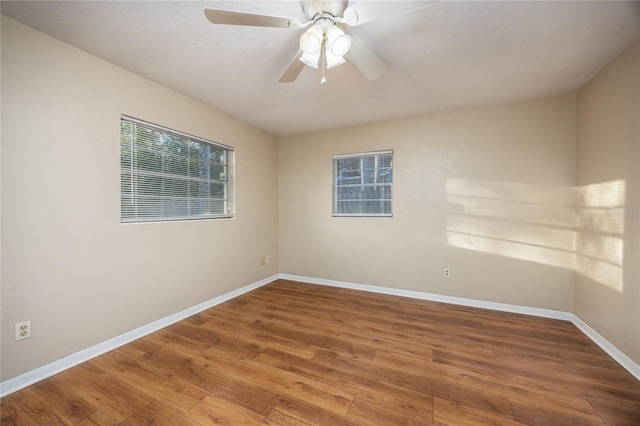 unfurnished room featuring a textured ceiling, wood-type flooring, and ceiling fan