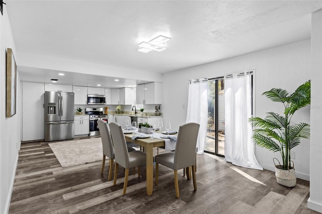 dining space featuring dark hardwood / wood-style flooring and sink