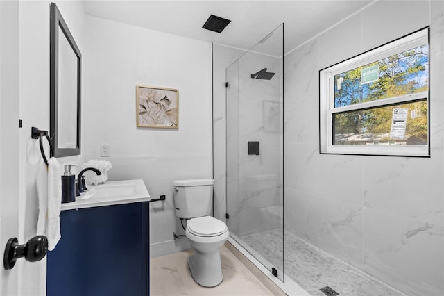 bathroom featuring walk in shower, vanity, and toilet