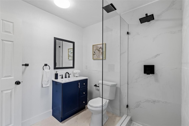 bathroom featuring vanity, a tile shower, and toilet