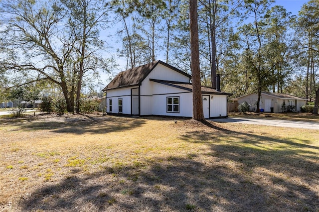 view of side of home featuring a lawn