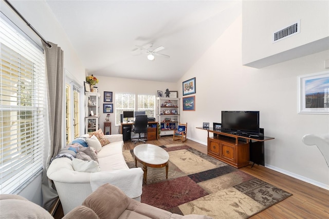 living room with dark hardwood / wood-style flooring, high vaulted ceiling, and ceiling fan