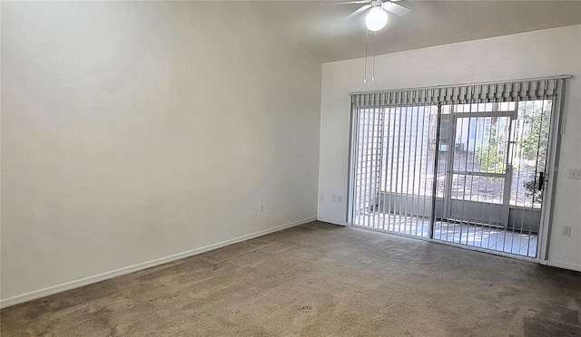 carpeted spare room featuring ceiling fan