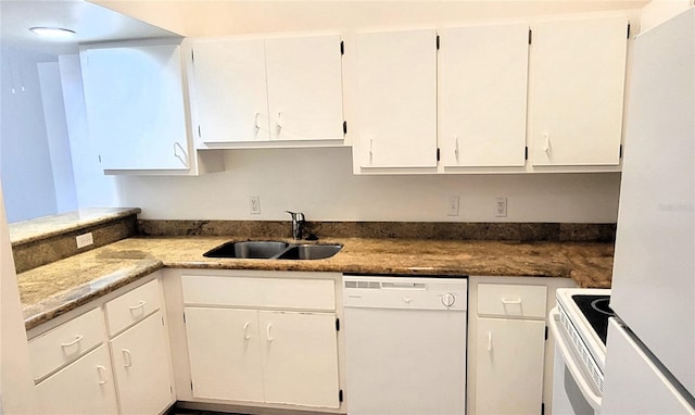 kitchen featuring white appliances, white cabinetry, and a sink