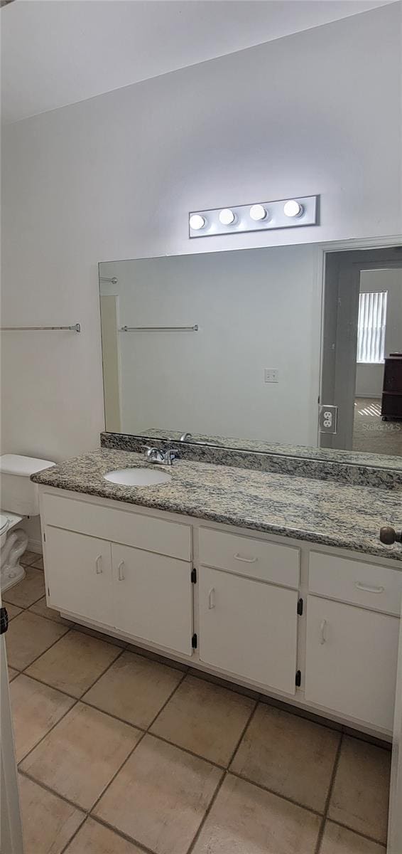 bathroom featuring vanity, toilet, and tile patterned floors