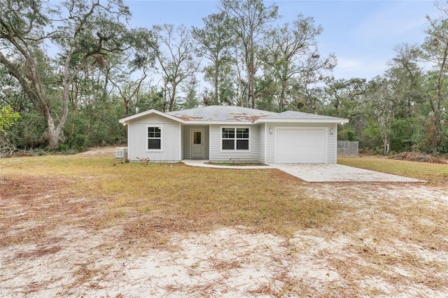 ranch-style home featuring a garage and a front yard