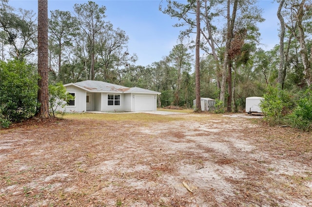 view of yard featuring a garage and a shed