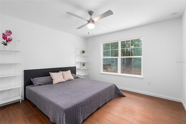 bedroom featuring dark hardwood / wood-style flooring and ceiling fan