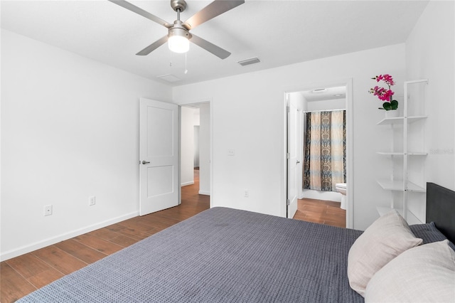 bedroom featuring dark wood-type flooring, ceiling fan, and connected bathroom