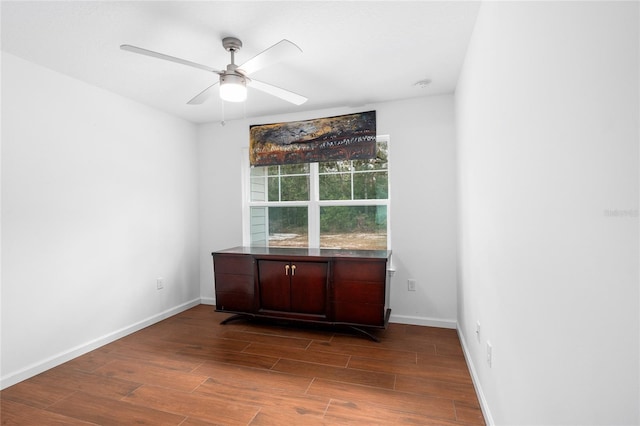 unfurnished room with ceiling fan and dark hardwood / wood-style floors