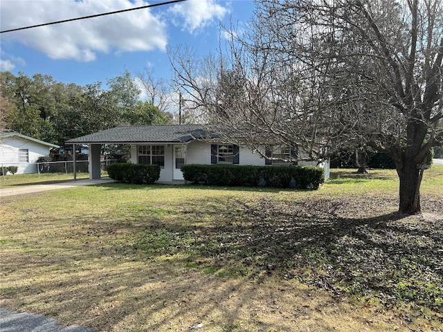 ranch-style home with a carport and a front yard