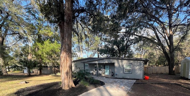 view of front of house with fence and a front lawn