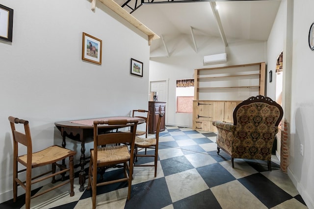 dining space featuring tile patterned floors, a wall mounted AC, baseboards, and vaulted ceiling