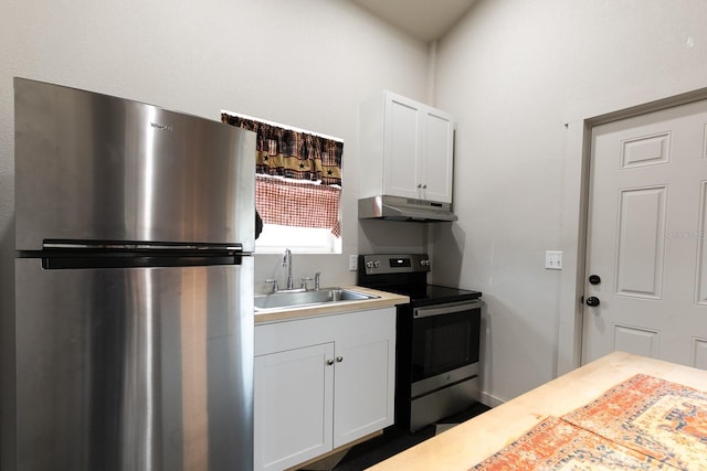 kitchen featuring under cabinet range hood, light countertops, appliances with stainless steel finishes, white cabinetry, and a sink