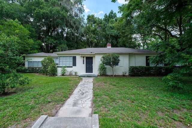 ranch-style home featuring a front yard