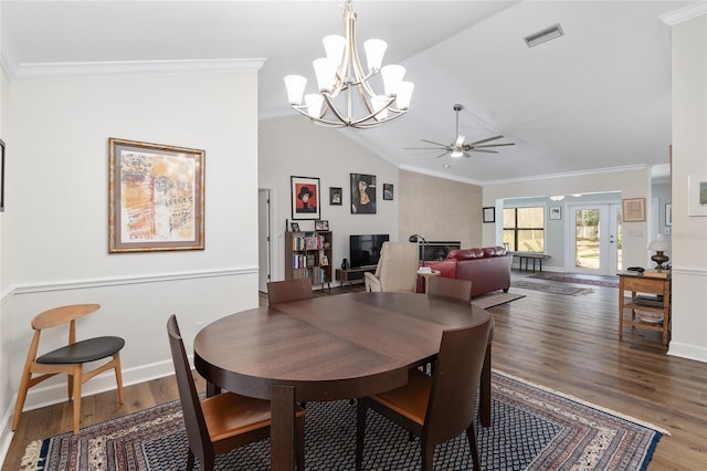 dining space featuring wood-type flooring, vaulted ceiling, ceiling fan with notable chandelier, and crown molding