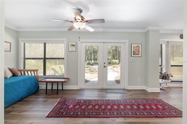 doorway with crown molding, plenty of natural light, dark hardwood / wood-style floors, and french doors