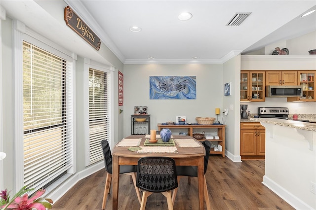 dining room featuring ornamental molding and dark hardwood / wood-style floors