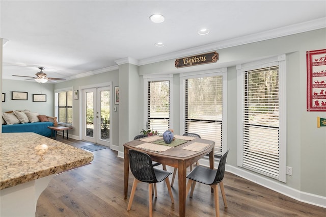 dining space featuring crown molding, ceiling fan, and dark wood-type flooring