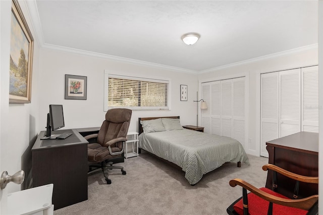 carpeted bedroom featuring crown molding and two closets