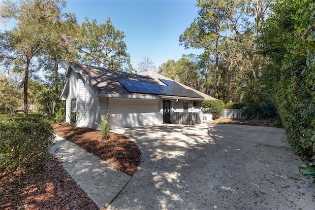 view of property exterior with a garage and solar panels