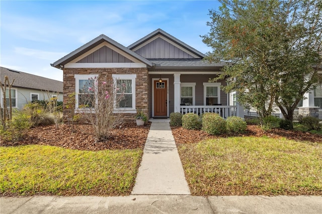 view of front of home with a porch and a front lawn