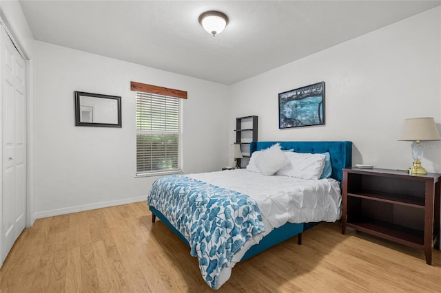 bedroom with hardwood / wood-style floors and a closet