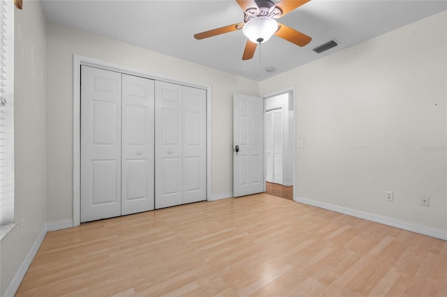 unfurnished bedroom with ceiling fan, light hardwood / wood-style floors, and a closet