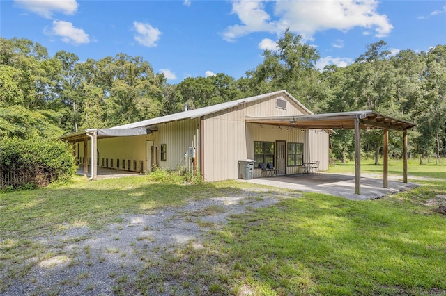 rear view of house with a yard and a carport