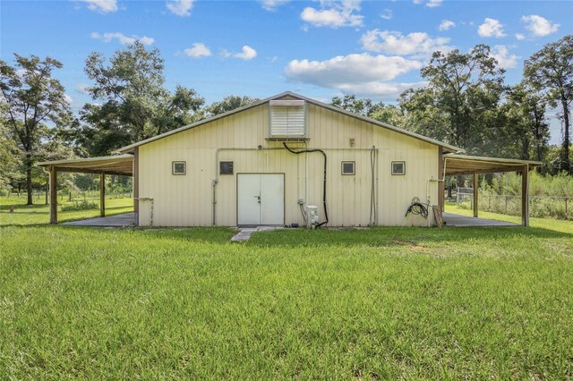 view of outdoor structure featuring a yard and a carport