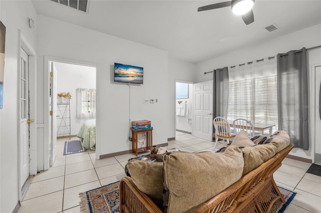 living room featuring light tile patterned floors and ceiling fan