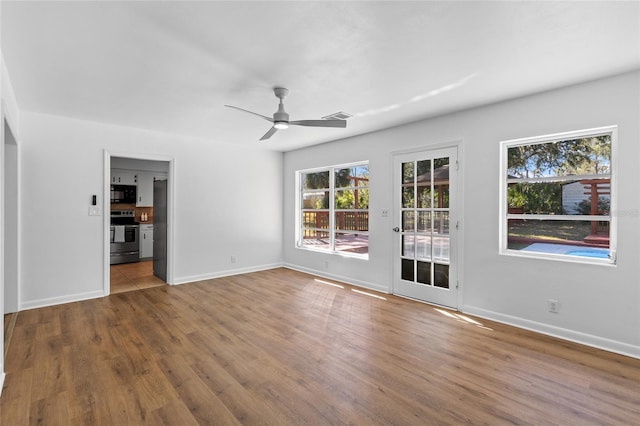 interior space with ceiling fan and light hardwood / wood-style flooring