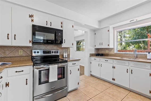 kitchen featuring sink, tasteful backsplash, light tile patterned floors, stainless steel electric stove, and white cabinets