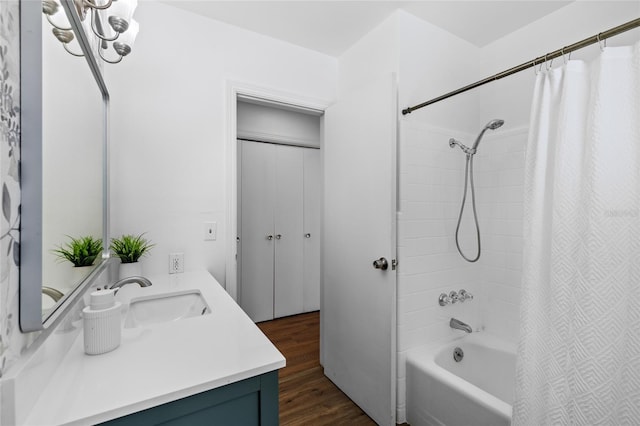 bathroom with wood-type flooring, shower / bathtub combination with curtain, and vanity