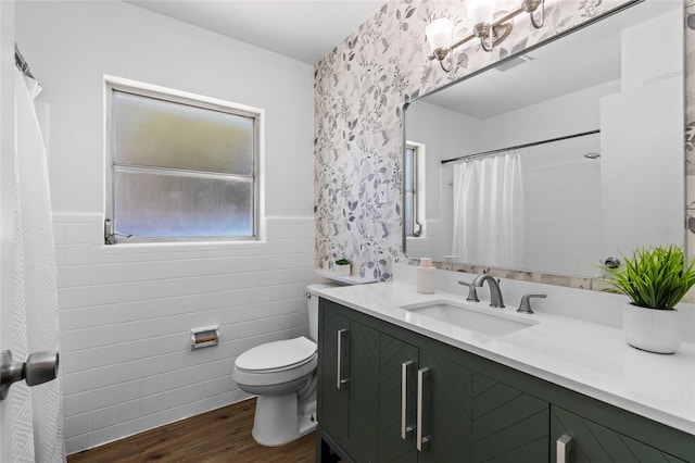 bathroom with wood-type flooring, tile walls, vanity, toilet, and a shower with curtain