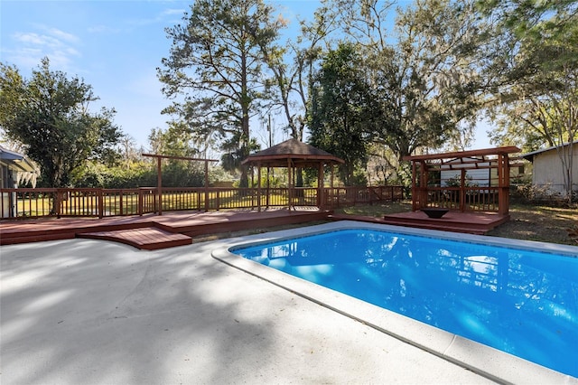 view of pool with a gazebo and a deck