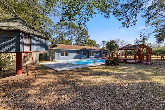 back of house with a gazebo, a fenced in pool, and a patio