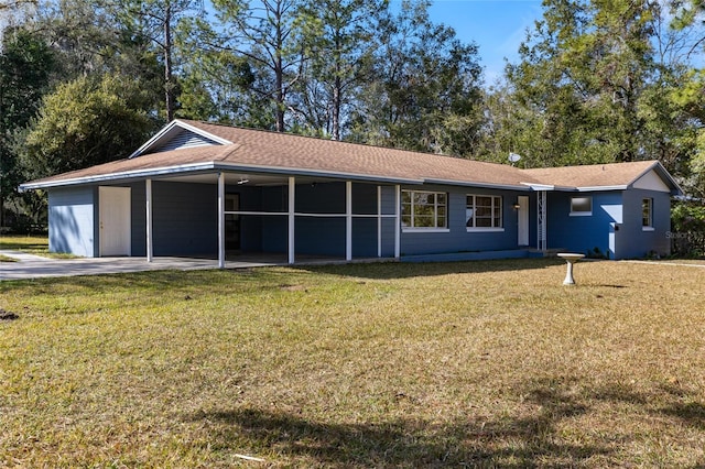 single story home with a front yard and a carport