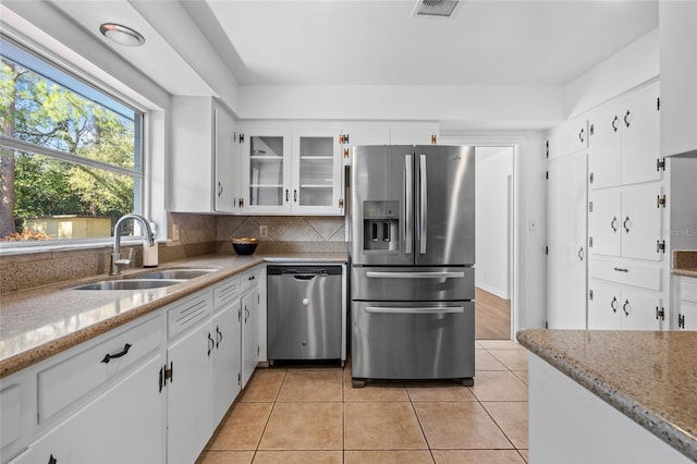 kitchen featuring appliances with stainless steel finishes, sink, and white cabinets